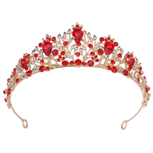 Detail of red teardrop crystals and gold floral hollow pattern on bridal crown