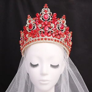 Baroque gold bridal crown with red crystals and white rhinestones on black background
