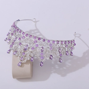 Macro shot of silver bridal crown featuring purple crystals and intricate rhinestone details