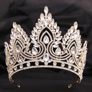 Detailed front view of baroque crystal bridal crown on black velvet background