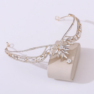 Detailed macro view of golden bridal crown with sparkling crystals and leaf patterns