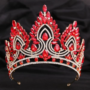 Detailed view of red crystal gemstones and gold metalwork on the Baroque bridal crown