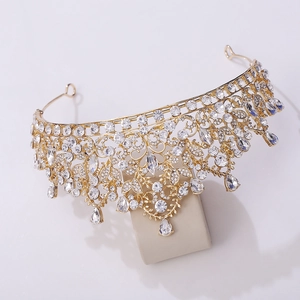 Detailed macro of golden luxury bridal crown with rhinestones and teardrop pendants