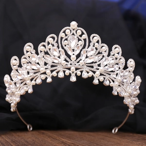 Macro shot of silver bridal tiara showing intricate pearls and sparkling rhinestone patterns