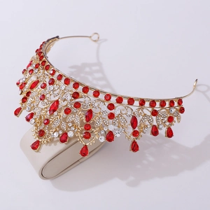 Detailed macro view of luxury bridal tiara with ruby red rhinestones and gold alloy frame
