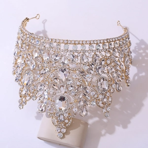 Detailed view of luxury gold bridal crown featuring teardrop crystals and ornate baroque alloy