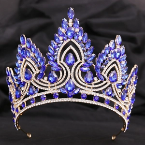 Detailed shot of golden baroque bridal crown with blue teardrop crystals and white rhinestones