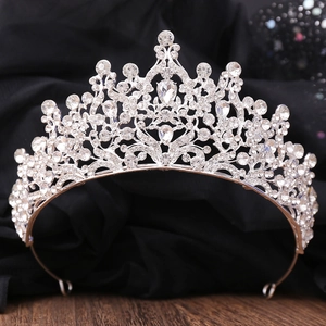 Close-up of elegant bridal crown with leaf-shaped rhinestones on black satin