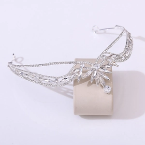 Elegant silver bridal crown with crystal leaf patterns and rhinestones on display stand
