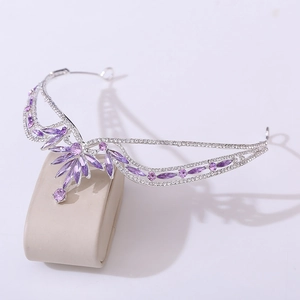 Macro detail of bridal crown with purple crystals and sparkling rhinestones on stand