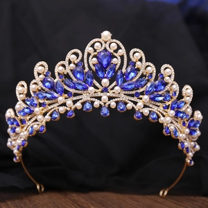 Detailed close-up of luxury bridal crown with deep blue crystals and white pearls