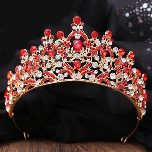 Detailed view of bridal tiara with red water-drop crystal and leaf-shaped gold alloy frame