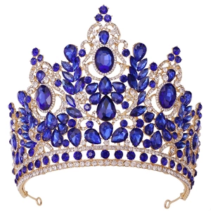 Detail of baroque gold crown with deep blue crystals and rhinestones for weddings