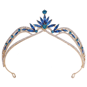 Close-up of golden bridal tiara featuring blue crystals and white rhinestones