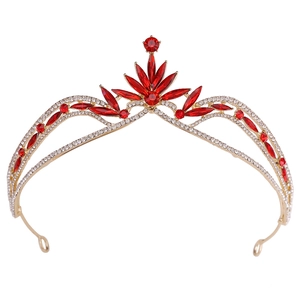 Detail view of gold baroque bridal crown with red crystals and leaf-shaped rhinestones