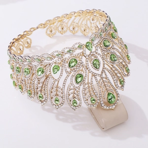 Détail d'une couronne de concours dorée avec pierres vert émeraude et cristaux blancs