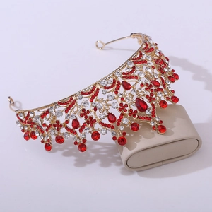 Detailed view of Baroque bridal crown with gold alloy leaf patterns and red rhinestones