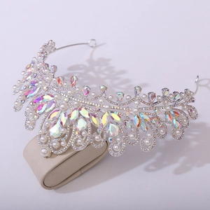 Detailed macro view of silver bridal crown with white pearls and iridescent crystals