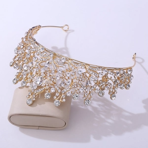 Macro shot of golden bridal crown details with sparkling leaf-shaped rhinestones