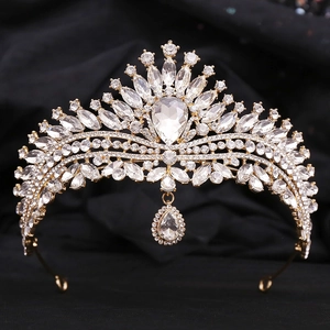 Macro shot of bridal tiara with sparkling crystal teardrop pendant and gold plating