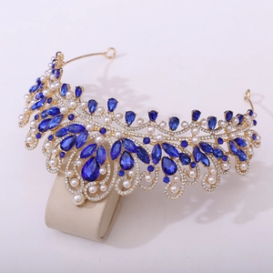 Detailed close-up of luxury bridal crown with blue teardrop crystals and white pearls