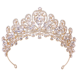Detailed close-up of golden bridal tiara featuring white pearls and marquise-cut crystals