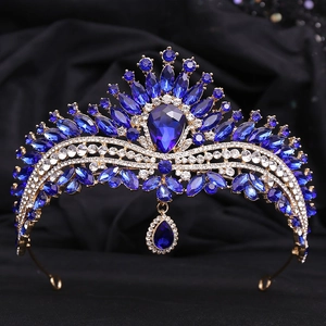 Detailed view of bridal crown featuring blue teardrop crystals and gold alloy base