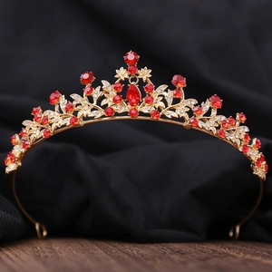Detailed macro view of vintage gold bridal crown with red water-drop rhinestones
