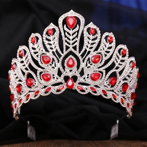 Detail of red crystals and silver alloy wings on a pageant crown with side combs
