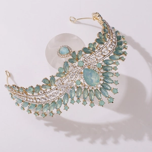 Detail of light green crystal bridal crown with teardrop gems and golden alloy frame
