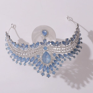 Close-up of bridal crown featuring light blue drop-shaped stones and white rhinestones