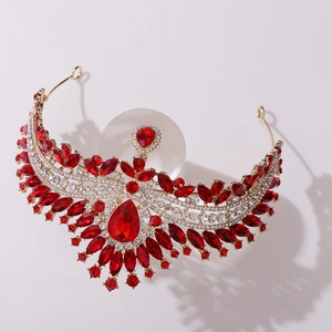 Detailed view of luxury gold bridal crown featuring large red gems and white crystals