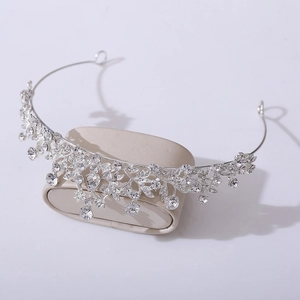 Detailed close-up of a silver bridal tiara with sparkling crystal leaves and floral patterns