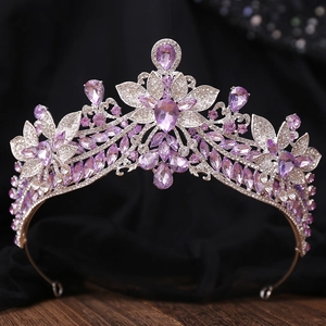 Detailed view of silver wedding crown featuring purple amethysts and floral rhinestone patterns