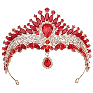 Macro detail of royal crystal crown with red gemstones and golden alloy framework