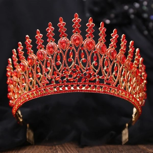 Detailed close-up of Baroque gold bridal crown featuring vibrant red crystals and hair comb