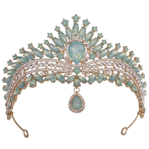 Detail of golden bridal tiara with light green drop-shaped crystals and small diamonds