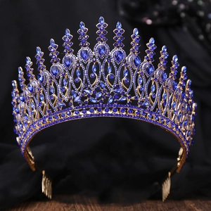 Detailed close-up of Baroque gold alloy crown with deep blue crystals on black silk