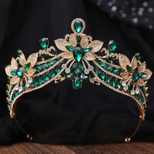 Detailed close-up of a vintage bridal crown with emerald green rhinestones and gold alloy frame