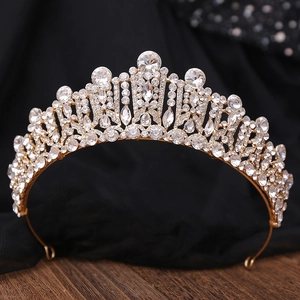 Detail of baroque bridal crown with faceted crystals and silver alloy base on wood