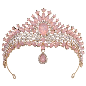 Close-up detail of golden bridal crown with pink crystals and shimmering rhinestones