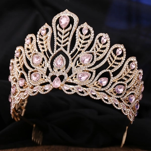 Macro detail of luxury gold tiara with pink teardrop gems and intricate diamond setting