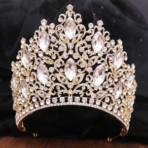 Macro detail of luxury gold bridal crown featuring intricate marquise crystal leaf patterns