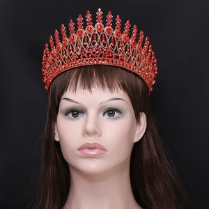 Baroque golden tiara with ruby red rhinestones and teardrop crystals on black background