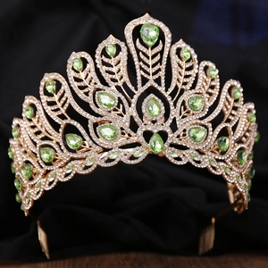 Exquisite gold peacock crown with emerald green teardrop gems and white rhinestones