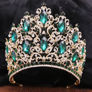 Macro detail of luxury emerald crystal bridal crown with golden baroque leaf filigree