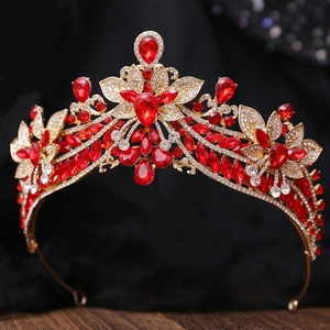 Macro shot of bridal crown featuring red pear-shaped rhinestones and golden alloy texture