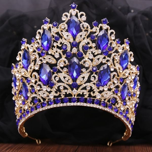 Close-up of golden bridal crown with blue marquise crystals and white rhinestones