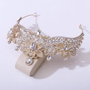 Detailed macro view of golden bridal tiara with intricate floral rhinestones patterns