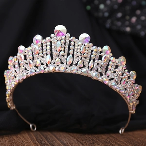 Baroque silver bridal crown with iridescent AB crystals on dark wooden background